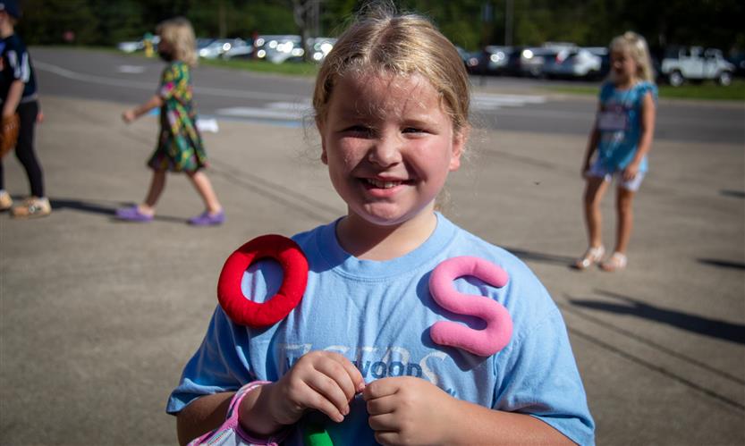 Girl wearing letters during a vocabulary parade
